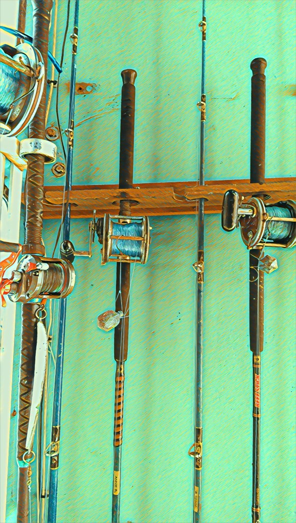 fishing rods in a holder on a boat