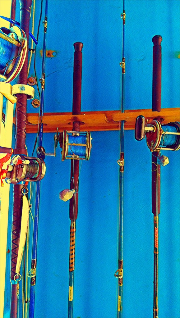 fishing rods in a holder on a boat